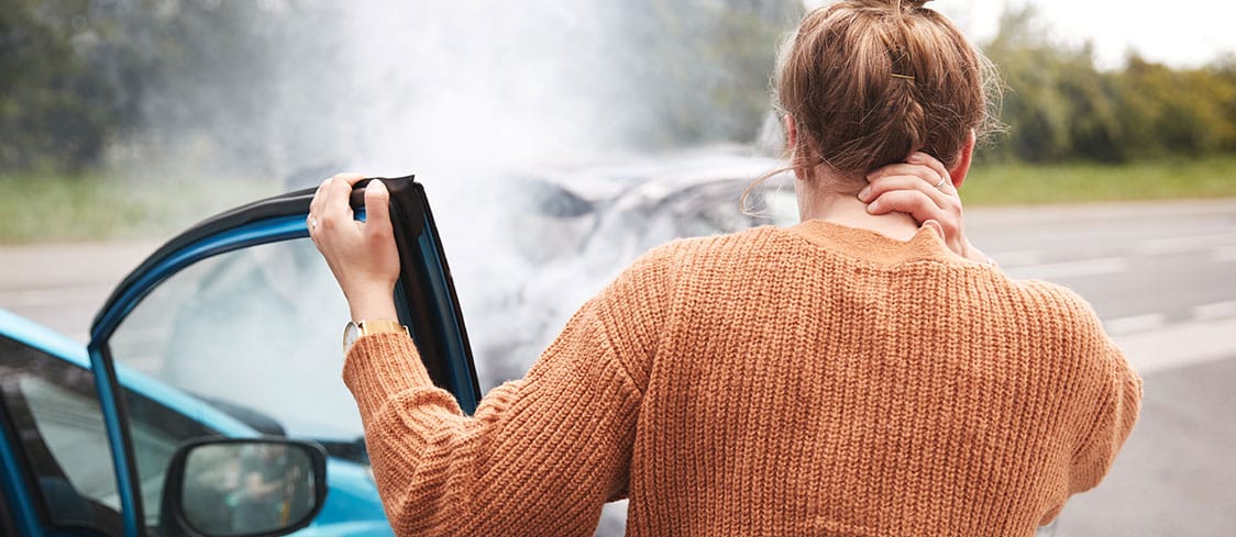 woman holding neck after car accident